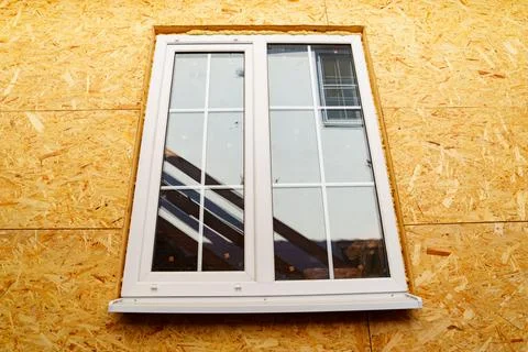 Wall with window on the structure of the block wooden house of wooden bars Stock Photos