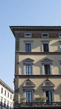 A wall with windows in an old building in the city of Florence, Tuscany (Ital Stock Photos
