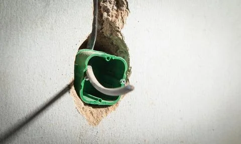 Wall with wire in socket holes. Preparation before installing socket Stock Photos