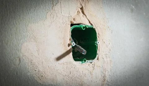 Wall with wire in socket holes. Preparation before installing socket Stock Photos