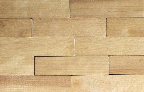A wall of wooden blocks. Rustic background for interior design. Close up. Stock Photos