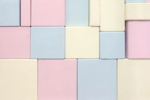 The wall of wooden rectangular shapes of different sizes of blue yellow and p Stock Photos