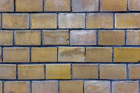 Wall from yellow bricks Stock Photos