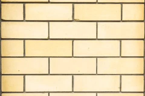Wall of yellow facing brick. Background for design. Stock Photos