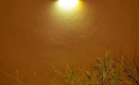 A wall with a yellow light shining on it Stock-Fotos