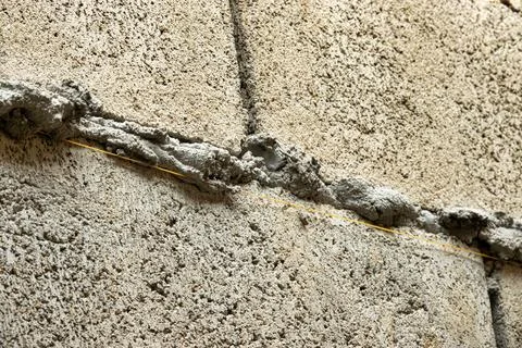 A wall with a yellow line on it Stock Photos