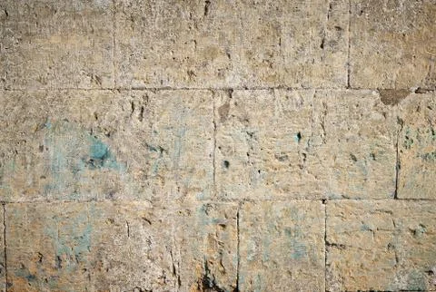 Wall of yellow rectangular stones with cement 스톡 사진