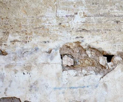 Wall of yellow rectangular stones with cement 写真素材