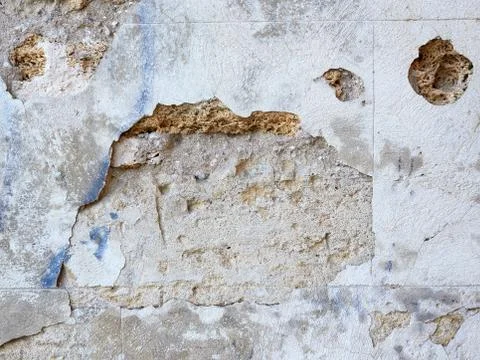 Wall of yellow rectangular stones with cement, fragment of ancient architectu 스톡 사진