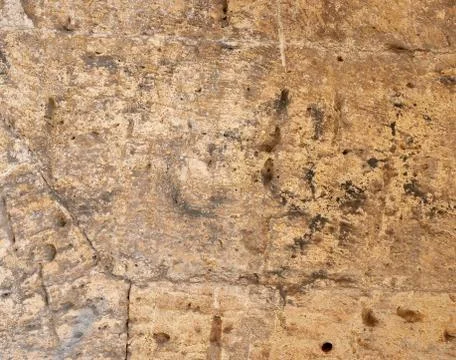 Wall of yellow rectangular stones with cement, fragment of ancient architectu 스톡 사진