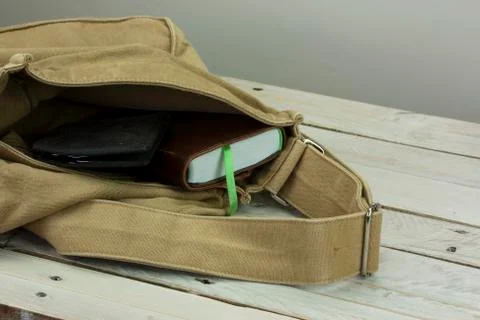 Wallet and book in an open bag Stock Photos