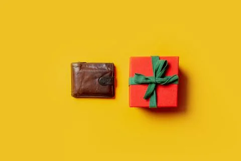Wallet and Holiday gift on yellow background Stock Photos