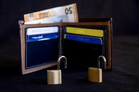 Wallet and open padlocks for security concept Stock Photos