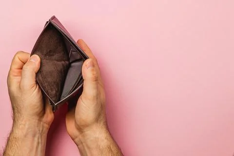 Wallet held open displaying emptiness amidst financial struggle and crisis Stock Photos