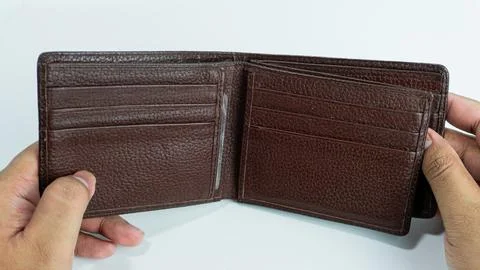 Wallet opened by hand isolated on white background Stock Photos