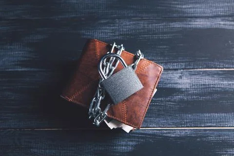 Wallet wrapped in a chain with a lock Stock Photos