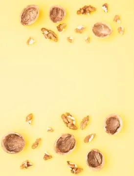 Wallnut seeds on yellow table, top view and copy space Stock Photos