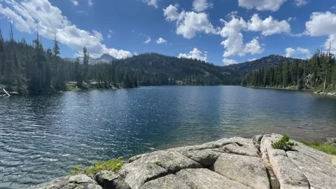 Wallowas Eagle Cap Wilderness: beautiful lake with white clouds and blue sky Video stock 329455031