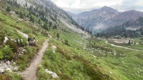 Wallowas Eagle Cap Wilderness: descending trail on edge of valley Video stock 329455009