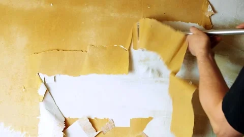 Wallpaper removal process with metal scraper Stock Footage 332987274