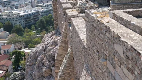 Walls of the acropolis Stunning view on Acropolis walls with Greek flag and Stock Footage 301436232