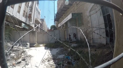 Walls, barriers, wire mesh, barbed wire in the city center of Hebron in Palestin Stock Footage 119794535
