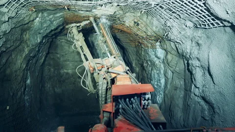 Walls of the underground mine are getting drilled by a bore. Underground Stock Footage 150818918