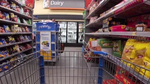 Walmart grocery retail store interior worker wearing face mask pushing cart Stock Footage 181380969