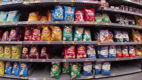 Walmart grocery retail store interior pan of potato chip aisle Stock Footage 181381282