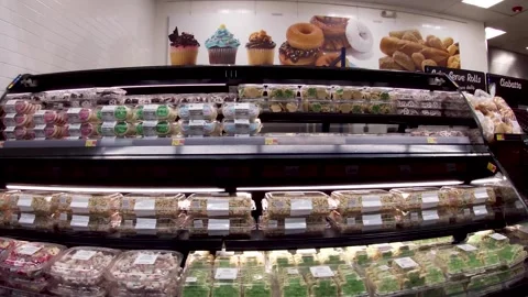 Walmart grocery retail store interior pan of bakery cakes and bread Stock Footage 181383693