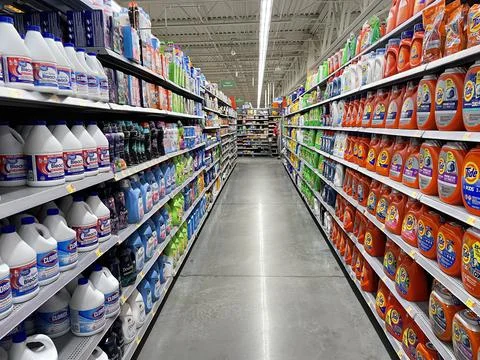 Walmart grocery store interior looking down laundry detergent aisle Stock Photos
