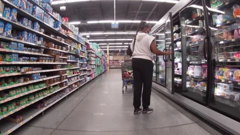 Walmart retail store interior customer wears face mask shopping in frozen foo Stock Footage 185651702
