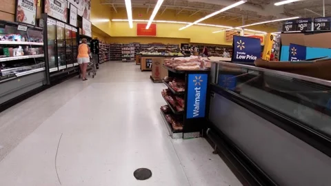 Walmart retail superstore interior meat area and people walking Stock Footage 158408847