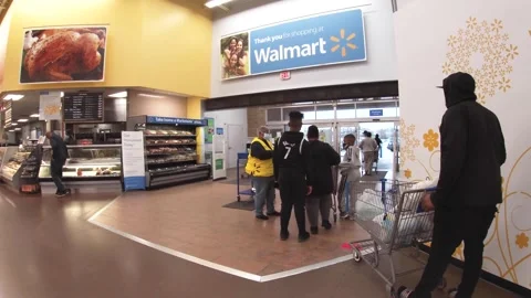 Walmart super center greeter checks some customer receipts Stock Footage 254512763