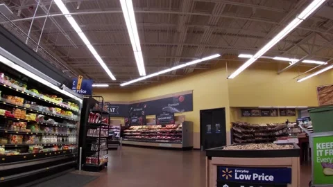 Walmart super center interior Browsing produce and young man walks by Stock Footage 157615041