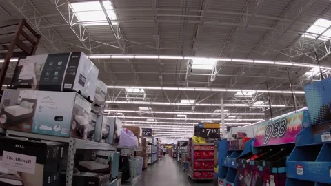 Walmart super center interior lady wearing a face mask and few people Stock Footage 157659564