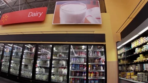 Walmart super center interior pan of dairy area worker wearing face mask Stock Footage 157659716