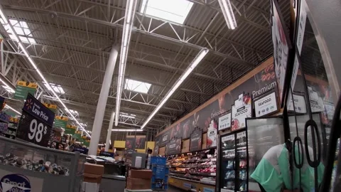 Walmart super center interior worker stocking wearing a face mask Stock Footage 157659770