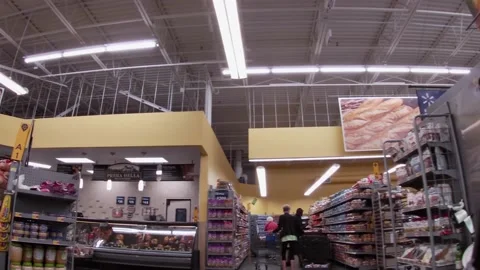 Walmart super center interior Worker in produce with face mask on Stock Footage 157659981
