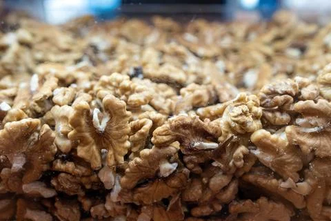 Walnut background. Peeled walnuts on display at a grocery store. Stock Photos