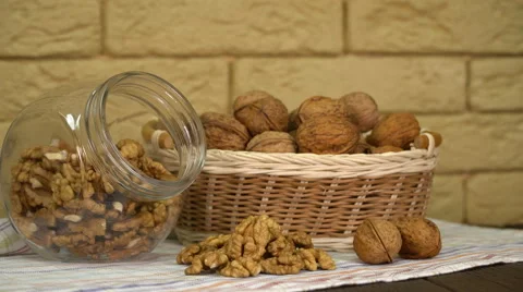 Walnut in basket and walnuts kernels on old wooden table. Video stock 63370416