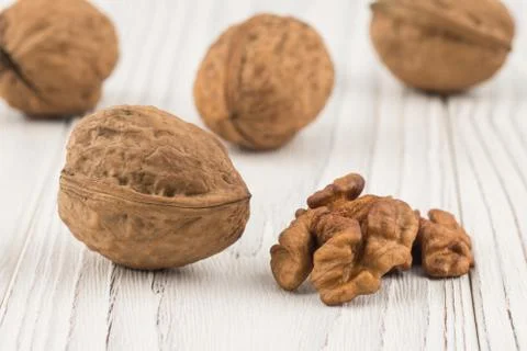Walnut closeup on an old white table. Stock Photos