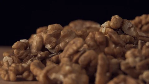 Walnut closeup. Walnut is crushed clockwise on a black background. Walnut Stock Footage 127918763