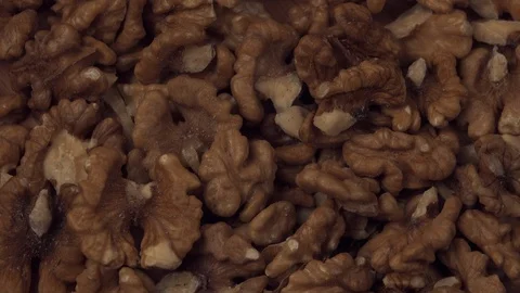 Walnut closeup. Walnut is crushed clockwise on a black background. Walnut Stock Footage 127919084