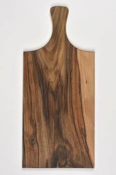 Walnut cutting board with handle on grey background Stock Photos