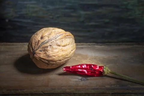 Walnut With Dried Pepper on Background Stock Photos