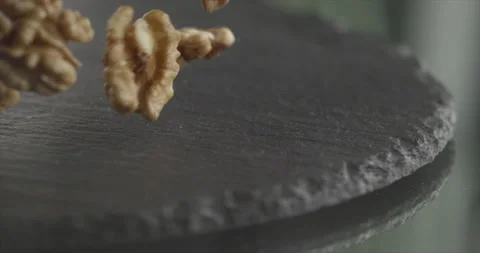 Walnut falls from a side on a black surface Stock Footage 197865712