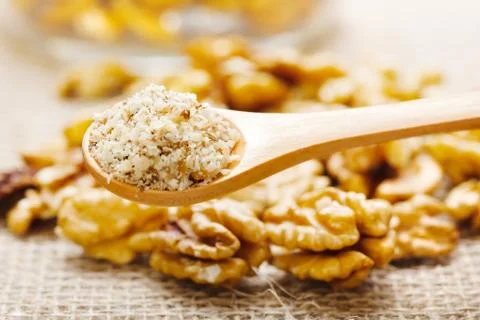 Walnut greound, nutmeat in background Stock Photos