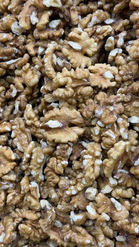 Walnut halves in close-up creating a textured brown background with a natur.. Stock Footage 332304006