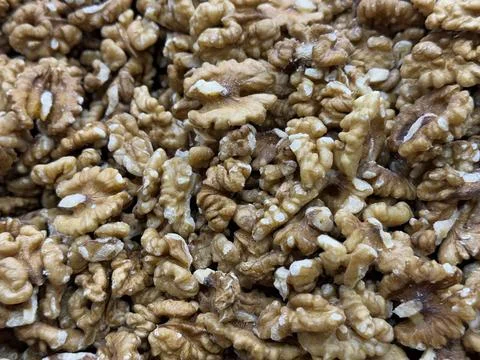 Walnut halves create a textured background featuring natural patterns and b.. Foto stock
